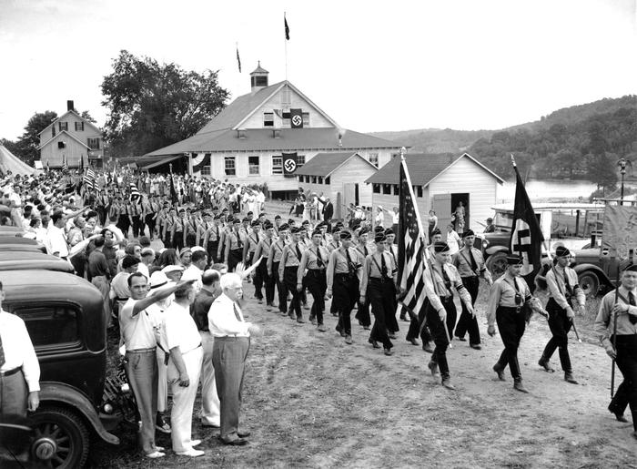 Nearly-1-000-uniformed-men-wearing-swastika-arm-bands-and-carrying-Nazi-banners-parade-past-a-review