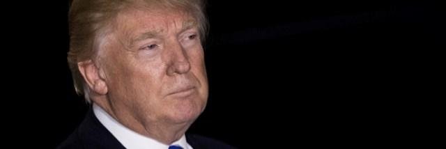 Donald Trump listens to questions from the press